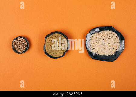 Different types of uses for hemp. Seeds, protein and powder in ceramic bowls. Stock Photo