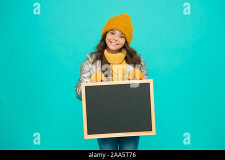 Happy hours. Promotion concept. Smiling girl wear winter outfit show blank chalkboard copy space. Fresh information. Schedule and working hours. Open hours. Winter entertainment and activities. Stock Photo