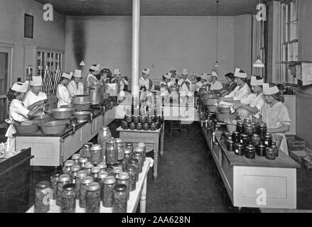 High School girls set the pace for their elders by conducting community canning centers. Taken in Lewis and Clark High School Spokane, WA ca. 1914-1919 Stock Photo