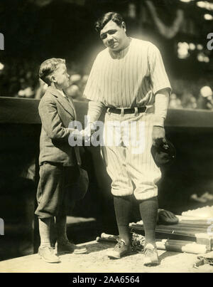 Legendary New York Yankee baseball player Babe Ruth poses for a photo with a young boy. Stock Photo