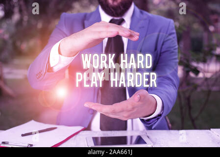 Conceptual hand writing showing Work Hard Play Harder. Concept meaning a Balance Life Have a Break Destressing to Relax Man in front of table. Mobile Stock Photo