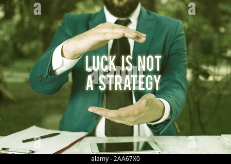 Conceptual hand writing showing Luck Is Not A Strategy. Concept meaning it is not being Lucky when planned intentionally Man in front of table. Mobile Stock Photo