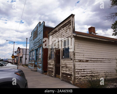 MCGILL, NEVADA - JULY 23, 2018: Old storefronts, with peeling paint, long empty, as well as the McGill Drugstore Museum housed in a genuine old Rexall Stock Photo