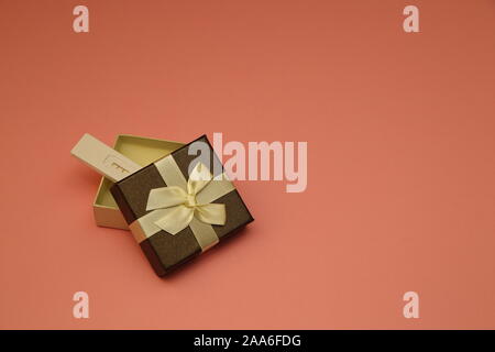 Positive pregnancy test in open decorative gift present box with bow isolated on pink background copy space Stock Photo