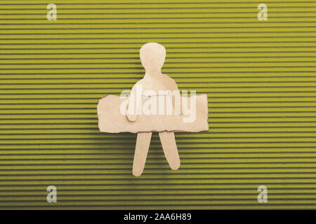 Paper man shape holding burnt note paper in hand Stock Photo
