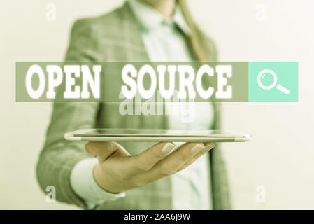 Writing note showing Open Source. Business concept for denoting software which original source code is made free Business concept with mobile phone an Stock Photo