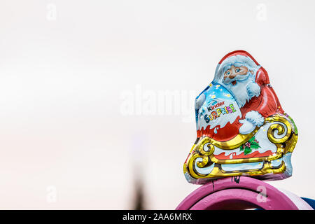 Kinder Surprise Santa Claus Christmas egg consists of a chocolate shell, a plastic capsule with toy, and external foil wrap. Made by Ferrero Co. Stock Photo
