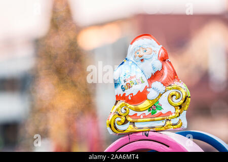 Kinder Surprise Santa Claus Christmas egg consists of a chocolate shell, a plastic capsule with toy, and external foil wrap. Made by Ferrero Co. Stock Photo