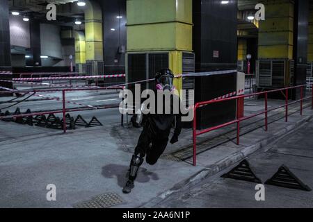 Hong Kong, China. 17th Nov, 2019. A protester runs with a molotov cocktail bottle on his hand inside a closed bus station during the clashes.Riot police and Protesters clashed in the surroundings of Hong Kong Polytechnic University after a day of relative calm, Clashes between protesters and riot police started at night when police tried to break in the barricades firing teargas and were received by protesters that responded with petrol bombs and bricks. Most of the fighting concentrated at the intersection of the school's main entrance. (Credit Image: © Ivan Abreu/SOPA Images via ZUMA W Stock Photo