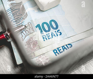Real - Brazilian Currency. Money bills in a paper holder. 100 reais notes. Stock Photo