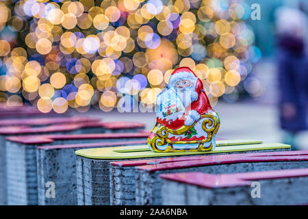 Kinder Surprise Santa Claus Christmas egg consists of a chocolate shell, a plastic capsule with toy, and external foil wrap. Made by Ferrero Co. Stock Photo