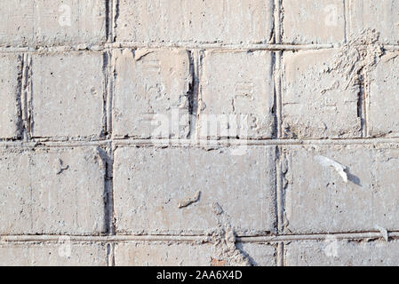 Old brick wall painted by gray paint closeup. Abstract background Stock Photo