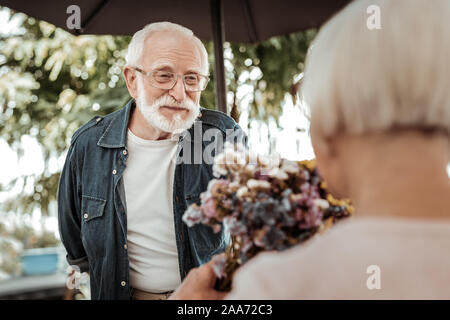 Positive nice aged man having a date Stock Photo