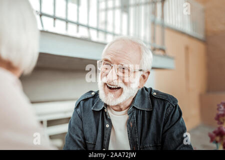 Joyful bearded aged man feeling absolutely happy Stock Photo