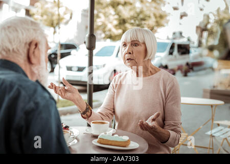 Cheerless aged woman having a quarrel with her husband Stock Photo