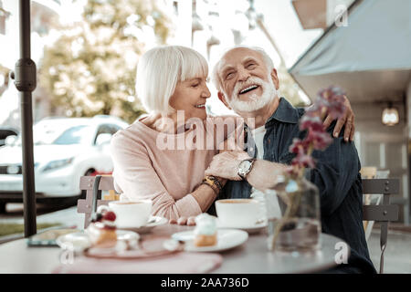 Nice happy couple sitting together in the cafe Stock Photo