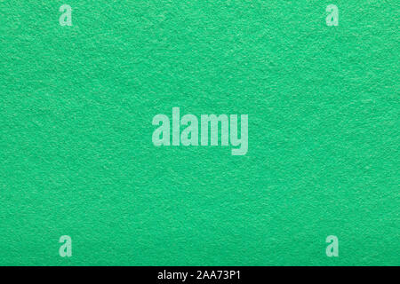 Fine grain felt green fabric. Texture background. Light green fleecy background. a shaggy fiber surface. Stock Photo