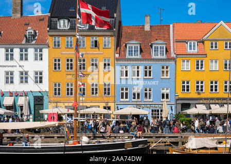 Copenhagen harbor, view in late spring of colorful waterfront buildings along the busy Nyhavn quay in the harbor area of Copenhagen, Denmark. Stock Photo