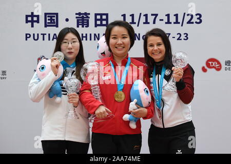 Putian, China's Fujian Province. 20th Nov, 2019. Gold medalist Zhang Jingjing (C) of China, silver medalist Kim Minjung (L) of South Korea and bronze medalist Monika Karsch of Germany pose during the awarding ceremony after the women's 25m pistol final at the ISSF World Cup Final in Putian, southeast China's Fujian Province, Nov. 20, 2019. Credit: Lin Shanchuan/Xinhua/Alamy Live News Stock Photo