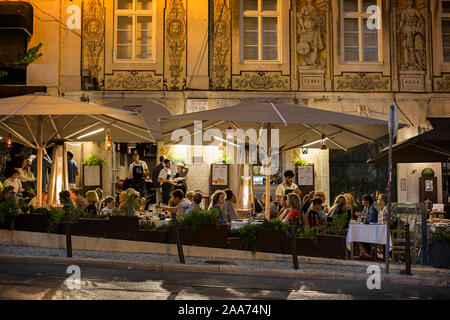 People dining al fresco on the Rua Trindade street in the Bairro Alto district in Lisbon, Portugal, in the evening. Stock Photo