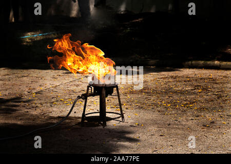 Flames caused by the explosion of the oil. Demonstration of water on oil fire. Stock Photo