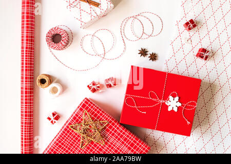 Christmas gift boxes with wrapping paper and decorations on white background. Festive concept. Stock Photo