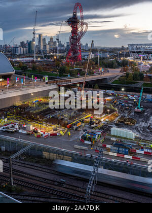 London, England, UK - November 4, 2019: Construction cranes stand over building sites beside the ArcelorMittal Orbit tower and Olympic Stadium during Stock Photo