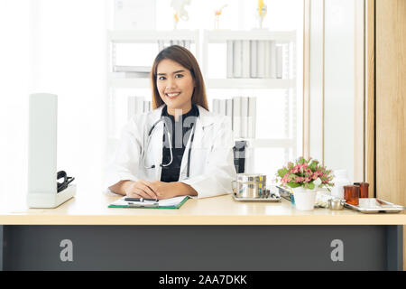 Portrait confident female doctor medical professional sitting in examination room in hospital clinic. Positive face expression Stock Photo