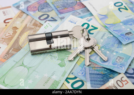 Keychain with lock on a background of varied euro bills Stock Photo