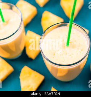 Pineapple smoothie with fresh pineapple on wooden table. Stock Photo