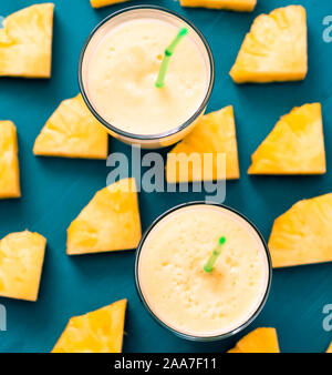 Pineapple smoothie with fresh pineapple on wooden table. Stock Photo
