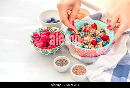 High protein healthy breakfast, buckwheat porridge with blueberries, raspberries, flax seeds and honey Closeup view Stock Photo