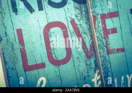 Love word printed on vintage wooden board. Calligraphy script love text. Stock Photo
