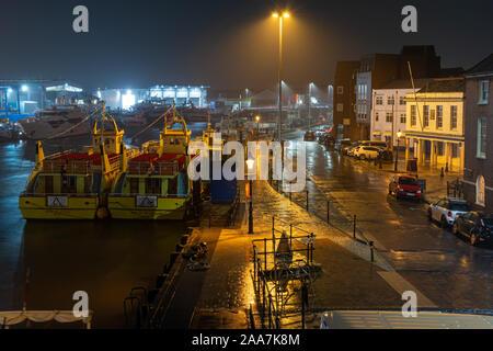 Poole, England, UK - October 3, 2019: Rain falls on the Quay and boats moored in Poole Harbour in Dorset. Stock Photo