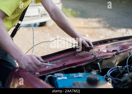 Car service ,fitting a car battery with wrench soft focus picture Stock Photo