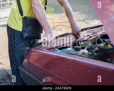 Car service ,fitting a car battery with wrench soft focus picture Stock Photo