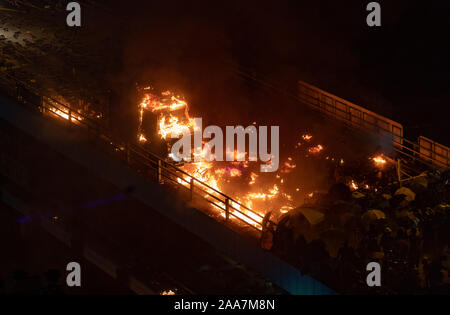 Hong Kong, China. 18th Nov, 2019. Demonstrators throw Molotov cocktails at the police armoured vehicle during the protests.Siege at Polytechnic University. Police surround the university campus after pro-democratic protesters blocked the cross-harbour tunnel and the major road outside the campus. Hong Kong protest continue for the sixth months. A citywide strike called for started on Monday 11 November, 2019 which brought parts of Hong Kong to halt as MTR stations closed and multiple roadblocks were erected. Credit: SOPA Images Limited/Alamy Live News Stock Photo