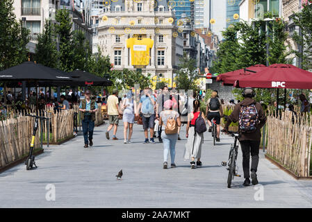 Brussels Old Town / Belgium - 07 05 2019: People walking down the pedestrain zone at the Anspach avenue in summer Stock Photo