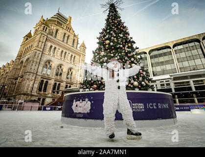London, UK. 20th Nov 2019. The Snowman character skates on the Natural History Museum Ice Rink in celebration of twenty-two years of performance at The Peacock theatre. Credit: Guy Corbishley/Alamy Live News Stock Photo