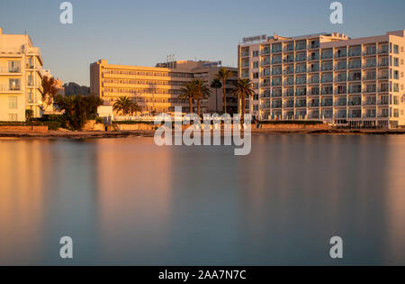 Cala Bona, Majorca, Spain, October 18, 2019, Levante Hotel from across the silky smooth bay just after sunrise. Stock Photo