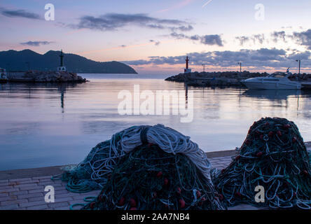 Cala Bona Marina at the start of a beautiful Sunrise with fishing nets and ropes ready for the fishing boats. Stock Photo