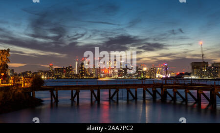London, England, UK - September 21, 2019: The sun sets behind skyscrapers and landmarks in the fast-evolving skyline of East London's regenerating Doc Stock Photo