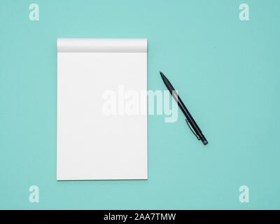 Top view workspace mockup on aqua background with open notebook and pen Stock Photo