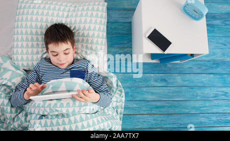 eight years old child sleeping in bed on pillow Stock Photo