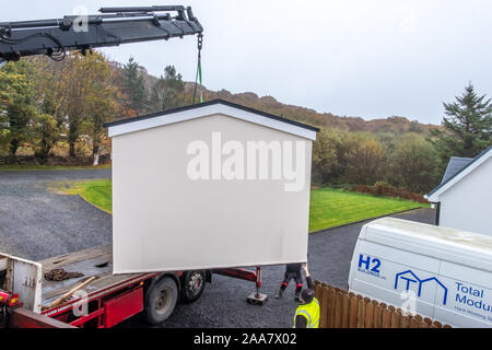 ARDARA / IRELAND - NOVEMBER 02 2019 : H2 buildings installing prefabric garage in the pooring rain Stock Photo