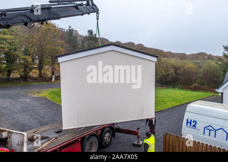 ARDARA / IRELAND - NOVEMBER 02 2019 : H2 buildings installing prefabric garage in the pooring rain Stock Photo