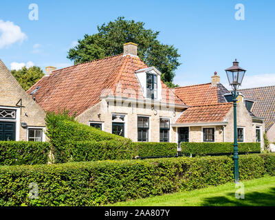 Facades of historic houses in Langestreek street on West Frisian island Schiermonnikoog, Netherlands Stock Photo