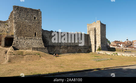 Rochester, England, UK - September 21, 2019: People sit in the sun under the walls of Rochester Castle in Kent. Stock Photo
