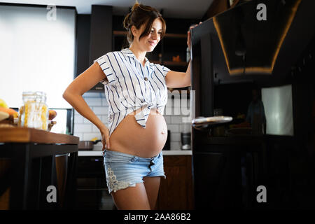 Beautiful pregnant woman looking for healthy food Stock Photo