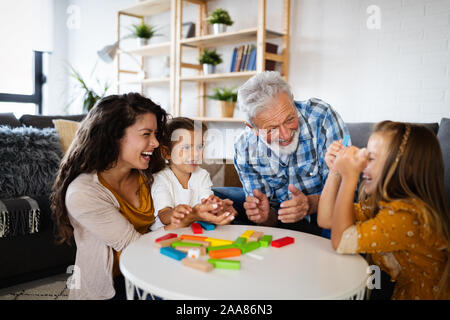 Happy family having fun time at home. Grandparent playing with children Stock Photo